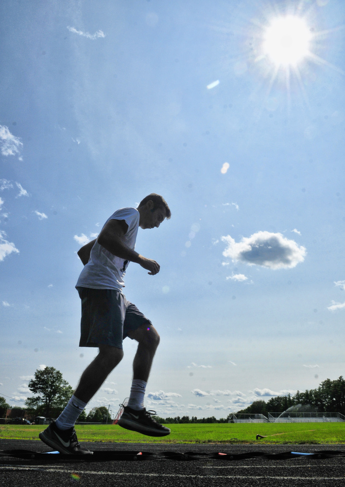 Hall-Dale soccer captain Tyler Nadeau hig- steps through an agility ladder duringan Aug 17 practice in Farmingdale.