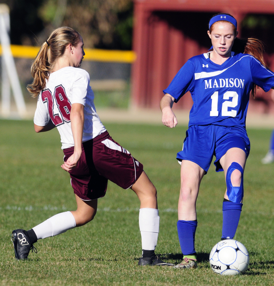 Monmouth forward Jordyn Gowell, left, and Madison midfielder Ashley Emery go for a ball during a Mountain Valley Conference game last season in Monmouth.