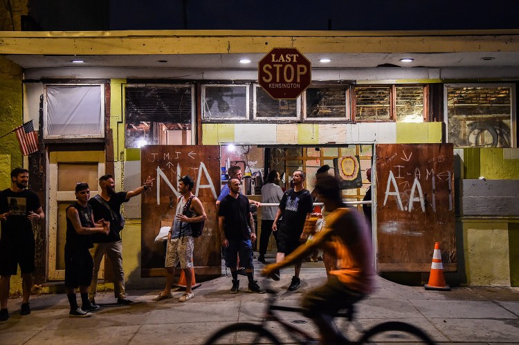 People gather outside the Last Stop, a Narcotics Anonymous and Alcoholics Anonymous group at Kensington Avenue and Somerset Street - the heart of drug use and sales in Philadelphia. 