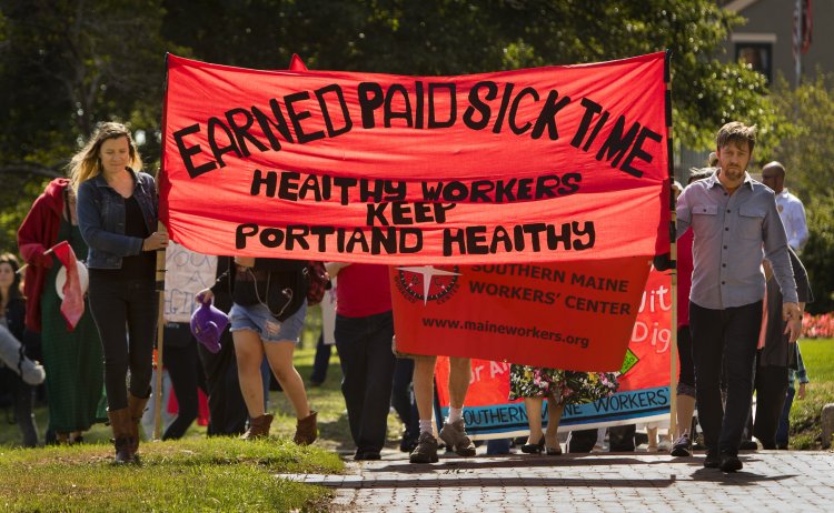 People walk up State Street on Labor Day to launch a campaign for earned sick time in Portland.
