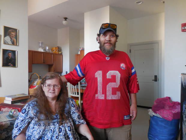 Susan and Phil Deschene in the Ash Street apartment where they've lived since July 2016. They may be evicted soon for growing marijuana plants inside.   Steve Collins/Sun Journal