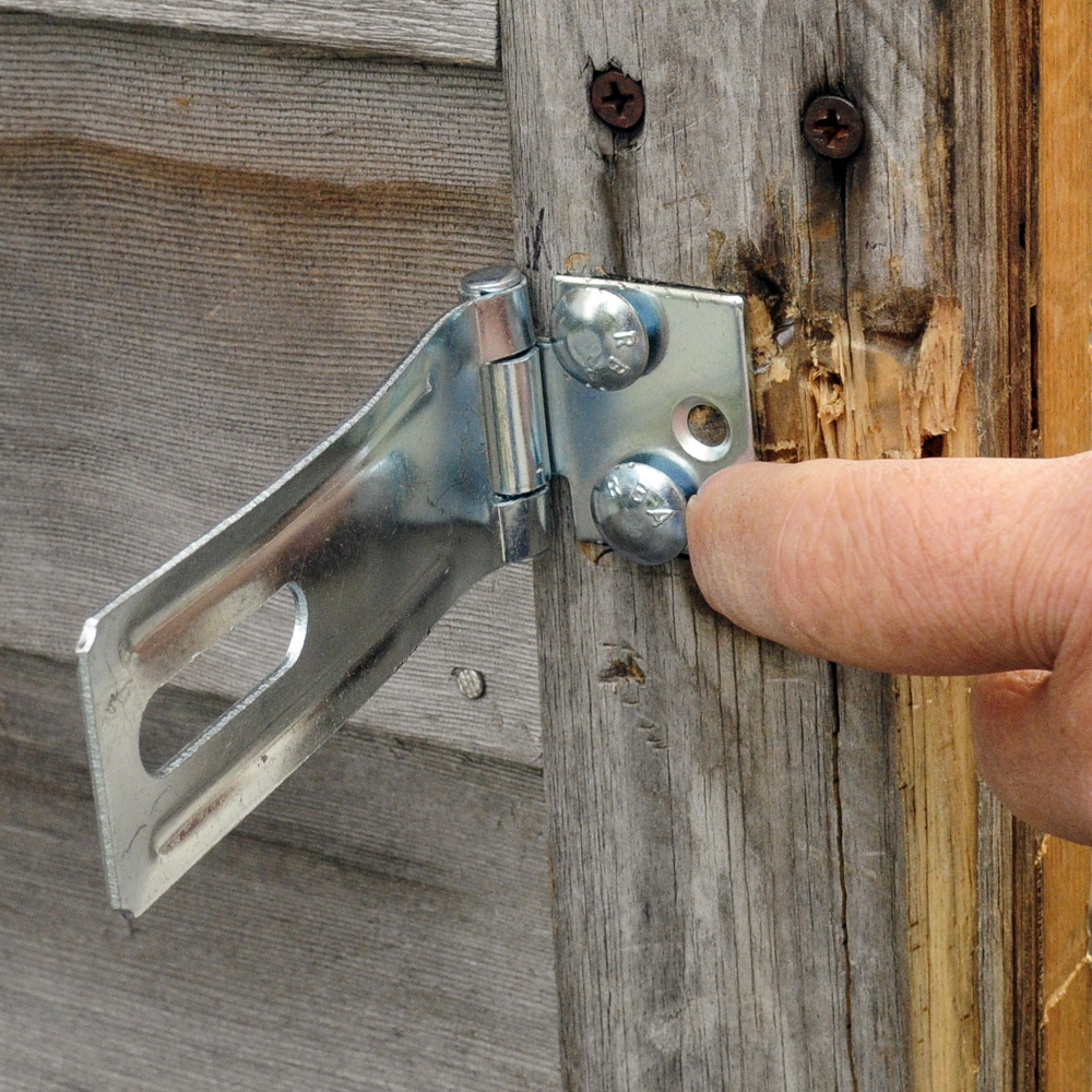 American Legion Post 4 Adjutant Roger Paradis points out on Friday the reinforced hardware added to a bottle storage shed after recent burglaries at the American Legion Smith Wiley Post 4 in Gardiner.