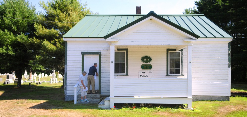 Sandra Lewis, left, and Dennis Keschl open the front door of the Old Town House in Belgrade in 2016. A public hearing on a ballot question that would allow the historical society to restore the house is scheduled for Tuesday.