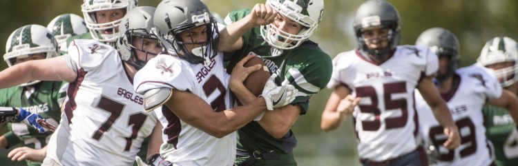 Ellsworth High School's Javon Williams (3) tackles Mount View High School's Jack Valleau (17) during the first quarter in Thorndike on Saturday.