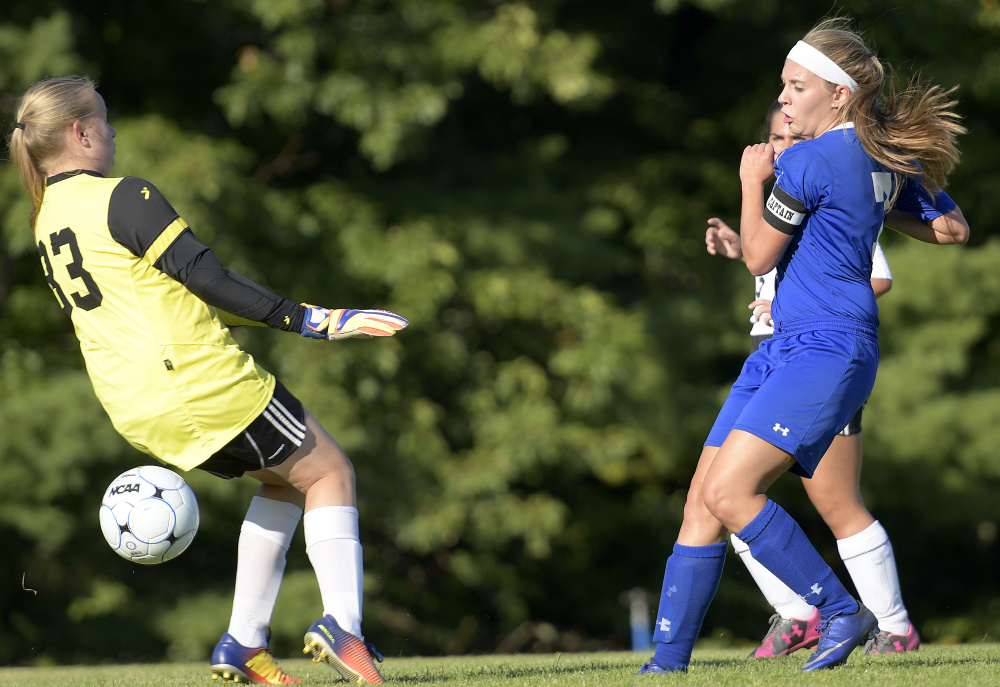 Madison senior Sydney LeBlanc, right, fires a shot past Hall-Dale goalie Riley Johnson during a Mountain Valley Conference game Tuesday afternoon in Farmingdale.