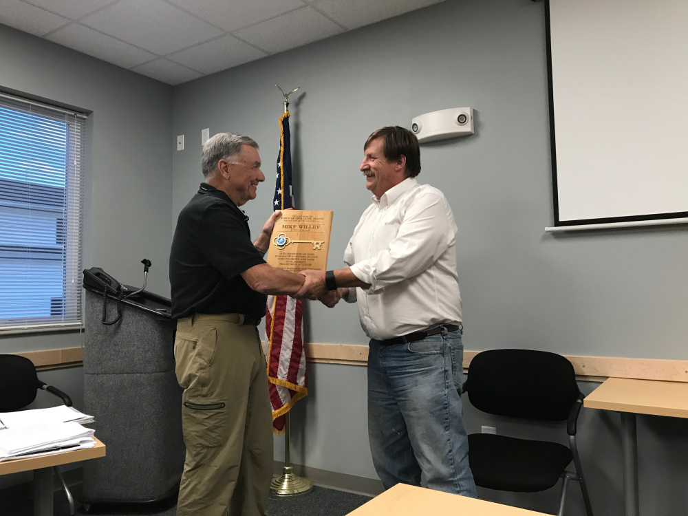 Mike Willey. left, accepts a symbolic key to the town of Oakland on Wednesday night from Town Council Chairman Michael Perkins.