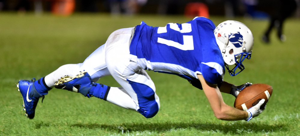 Madison's Sean Whalen gets his finger tips on a pass for the reception during a game against Winslow last season.