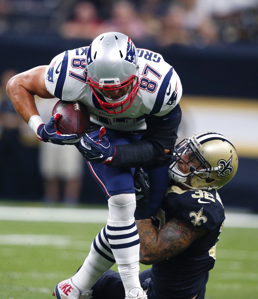 New England Patriots tight end Rob Gronkowski carries against New Orleans Saints strong safety Kenny Vaccaro in the first half Sunday.