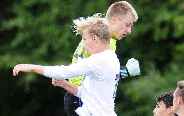 Erskine goalkeeper David McGraw, top, leaps with forward Michael Sprague, front, as they celebrate Sprague's goal that put the Eagles up 1-0 over Gardiner during a Class B North game last Friday in South China.