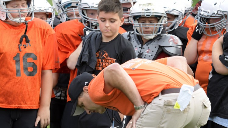 Gardiner youth football coach Dan Burgess talks to his team Wednesday during practice.