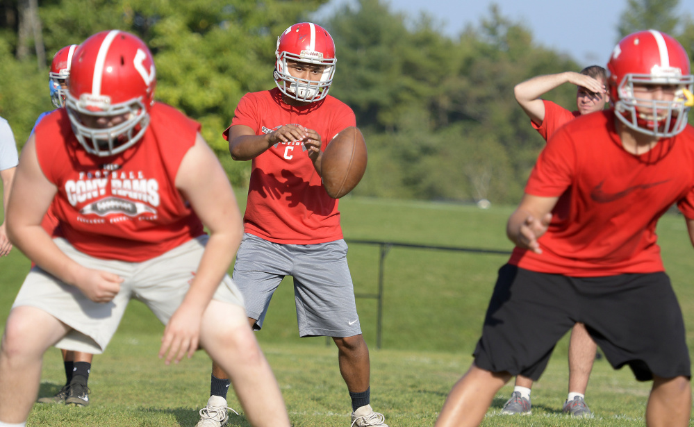 Members of the Cony football team run a drill during practice Monday at the Augusta school.