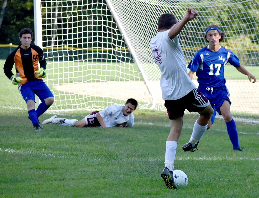 Monmouth's Thomas Neal looks to get a shot off while teammate Nate Camarie lays on the ground and Mountain Valley's Jacob Rainey (99) and Moritz Wehrheim await the shot during a Mountain Valley Conference game Tuesday in Monmouth.