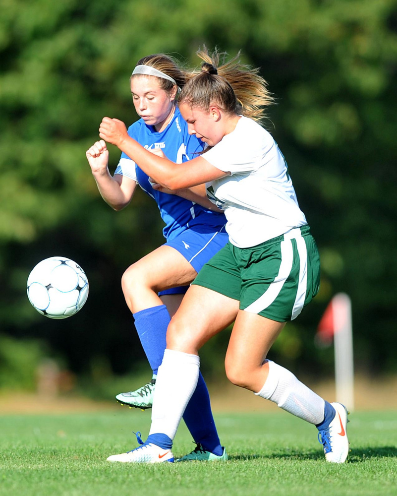 Carrabec High School's Annika Carey, right, collides with Oak Hill High School's Sydney Drew (2) left, in North Anson on Wednesday.