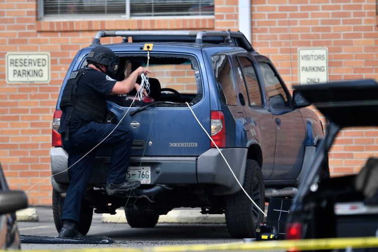 Police investigate the scene outside the Burnette Chapel Church of Christ after a deadly shooting at the church on Sunday.