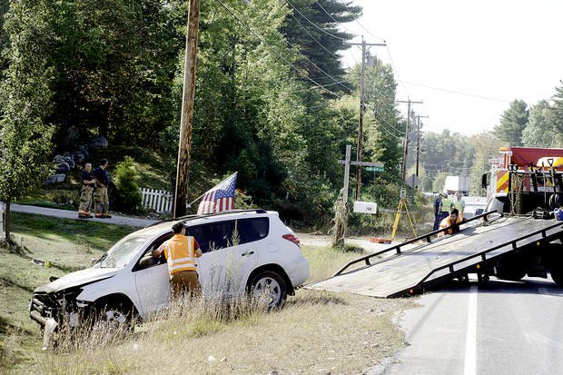 A wrecker crew loads the Toyota SUV that was involved in a fatal pedestrian crash onto a flatbed trailer on Wednesday morning in Poland.