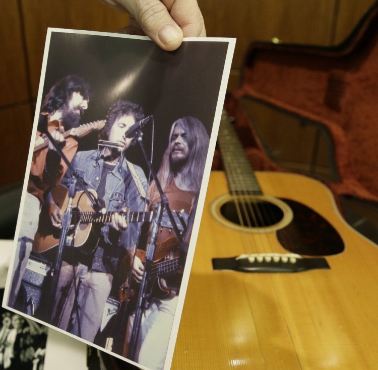 A photo shows Bob Dylan playing a 1963 acoustic guitar that will be auctioned Nov. 11. Heritage Auctions said Dylan played the guitar through his set at George Harrison's Concert for Bangladesh in New York in 1971.