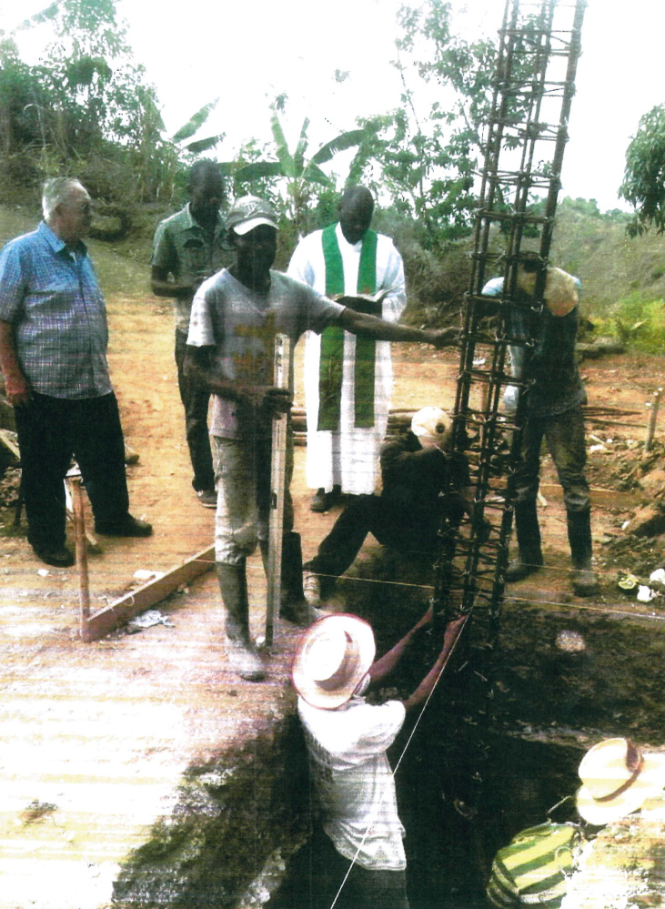 Father Real "Joe" Corriveau, left, a Winthrop native, watches the blessing in early 2017 of a construction project to replace a Catholic church in Haiti that was destroyed in a 2010 earthquake. The parish, which Corriveau started, is building a new church with funds that have been raised in the Winthrop community.