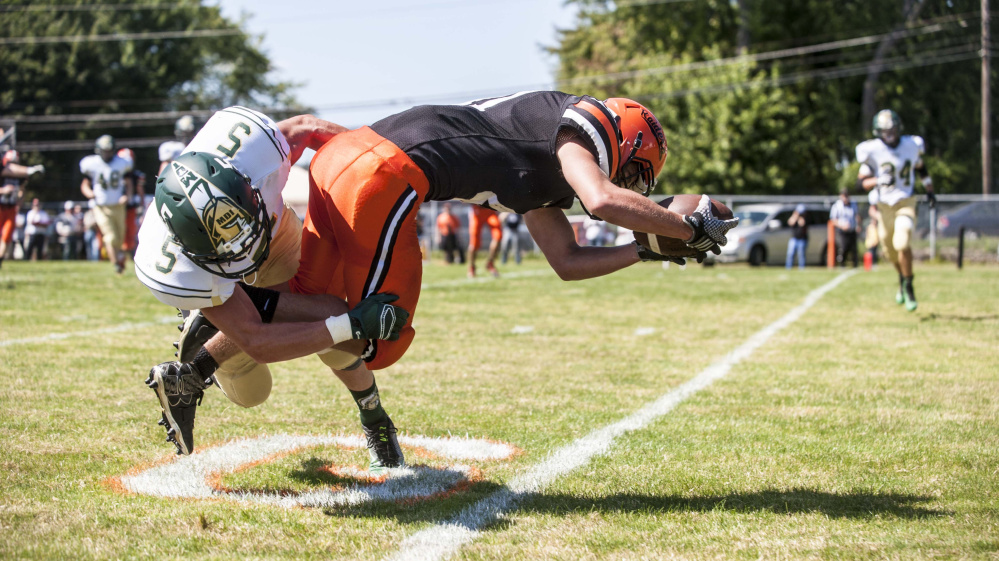 Winslow running back Benjamin Dorval (41) stretches over the goal line for a touchdown during a game against Mount Desert Island earlier this season.