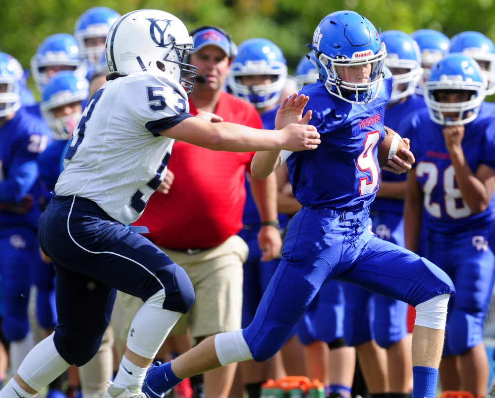 Oak Hill quarterback Gavin Rawstron is forced out of bounds during a game against Yarmouth earlier this season in Wales.