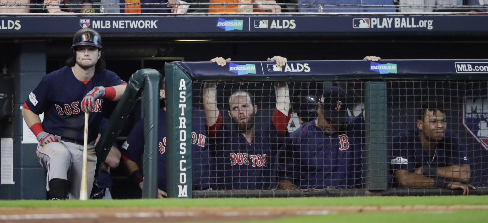 Boston Red Sox' outfielder Andrew an, left, waits to bat during the ninth inning in Game 2 of the American League Division Series in Houston. Houston won 8-2.