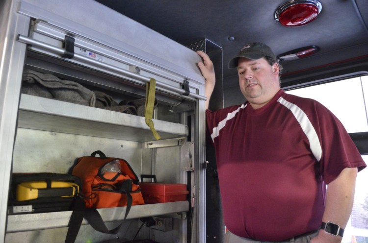 Richmond Fire Chief Matt Roberge talks about the defibrillator, in the yellow box, and other first aid equipment, in the orange case, carried on the department's truck during an interview Thursday at the Richmond fire station.