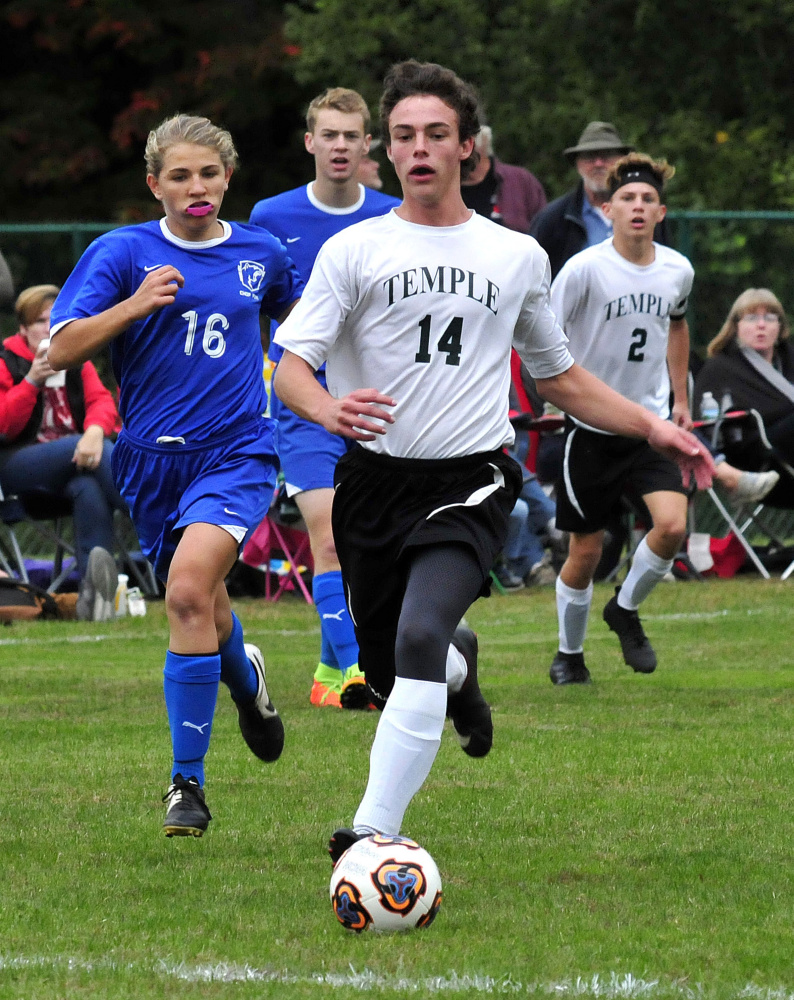 Temple Academy's Noah Shepherd races up field as Chop Point defender Josie Harrington pursues during a game Wednesday in Waterville.