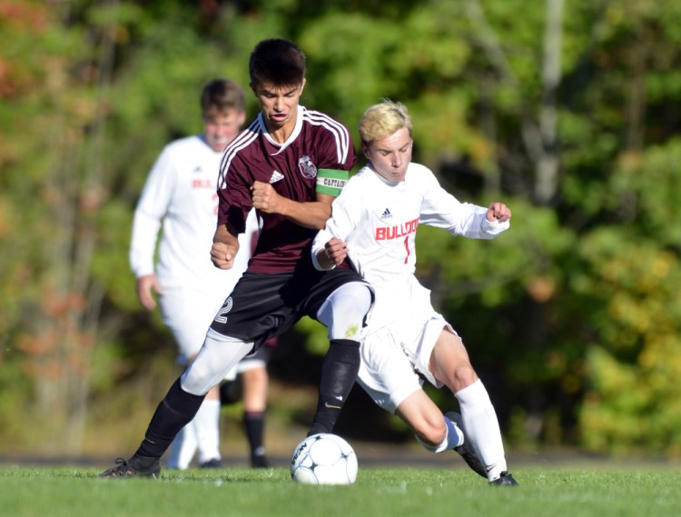 Monmouth Academy's Avery Pomerleau, left, and Hall-Dale's Josh Nadeau battle for ball during a game Thursday in Farmingdale.