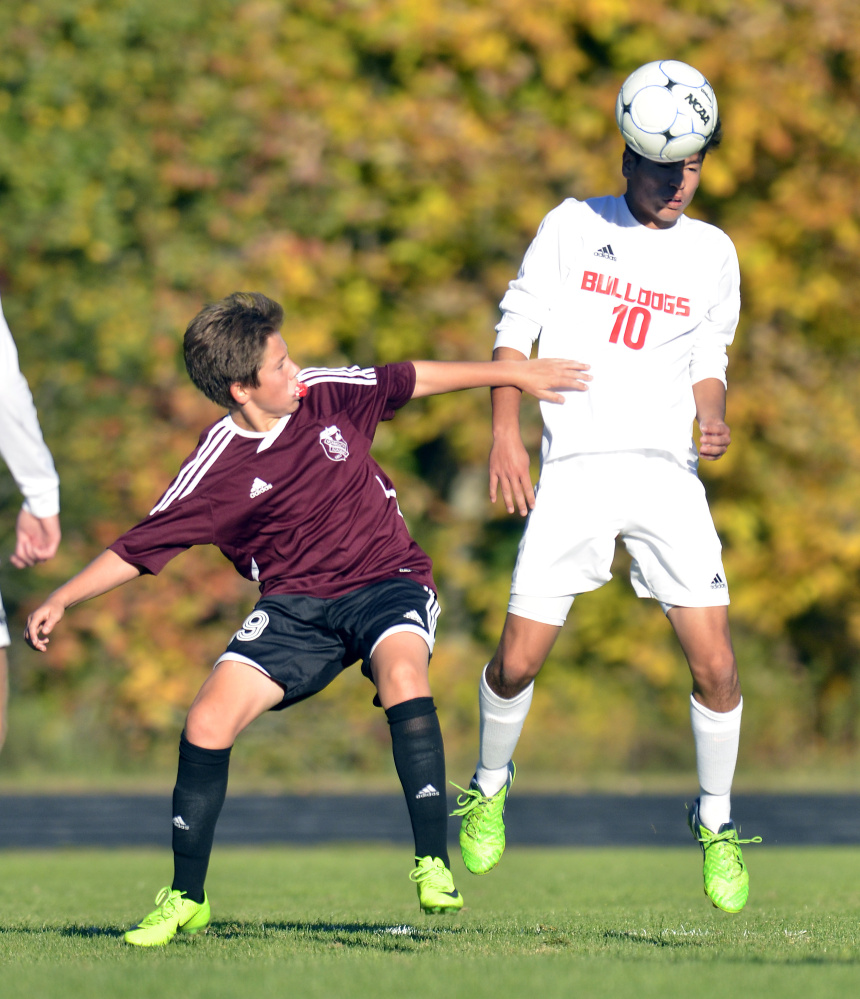 Monmouth Academy Cameron Armstrong, left, and Hall-Dale's Akira Warren battle for ball during a game Thursday in Farmingdale.