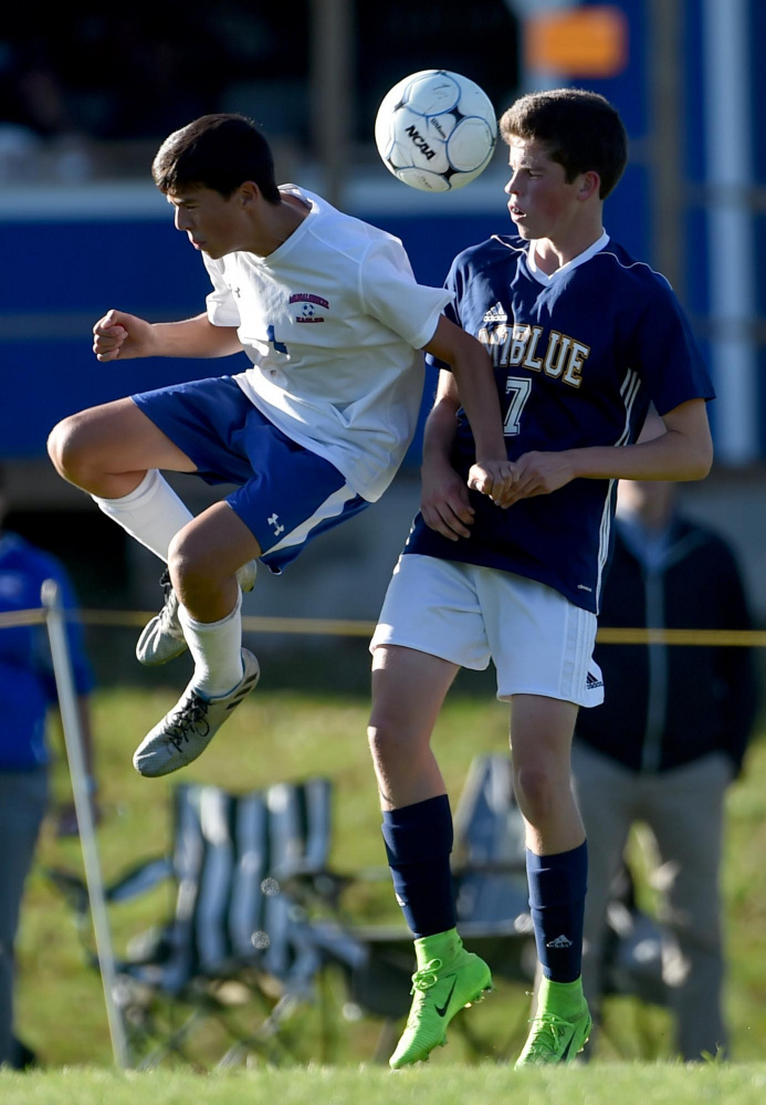 Messalonskee's Jacob Perry (1) left, battles for the ball with Mt. Blue's Mick Gurney, right in Oakland on Thursday, Oct. 12, 2017.  (Staff photo by Michael G. Seamans/Staff Photographer)