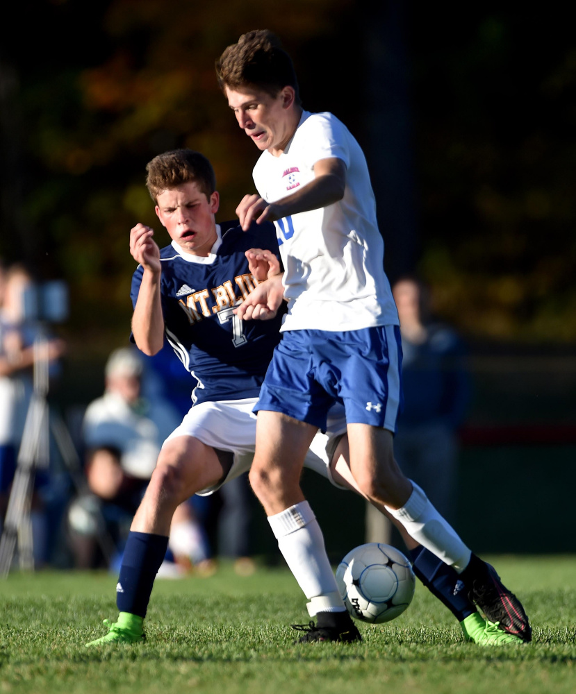 Messalonskee's Hunter Smith (10) collides with Mt. Blue's Mick Gurney (7) in Oakland on Thursday.