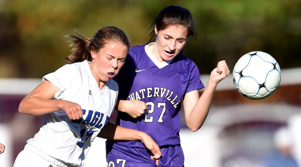 Erskine sophomore Morgan Presby battles for the ball with Waterville's Lilyan Foster during a Class B North game Friday in South China.