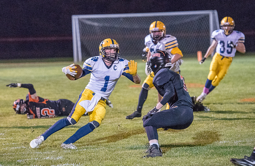 Mt. Blue's Ethan Andrews tries to get past Brunswick defender Noah Goddard  during a Pine Tree Conference Class B game Friday night in Brunswick.