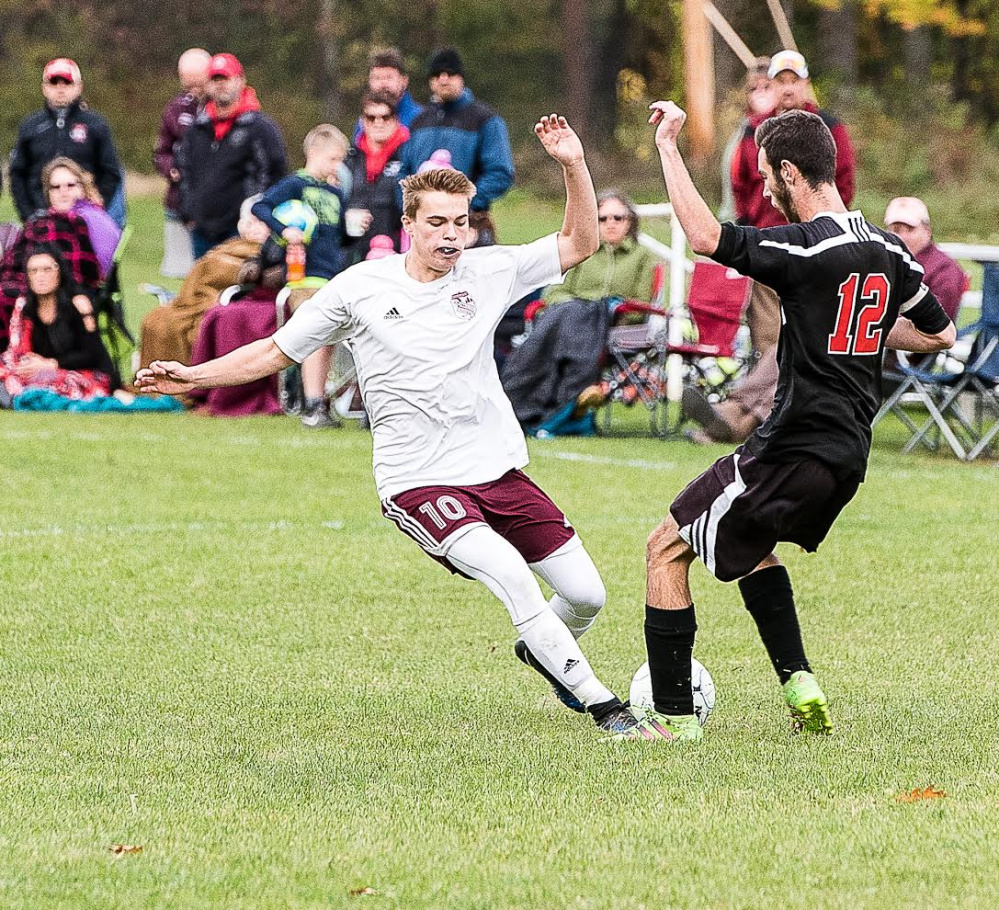 Monmouth's Gabrial Martin and Lisbon's Steve Martin go for the ball during a game Monday at Monmouth Academy.