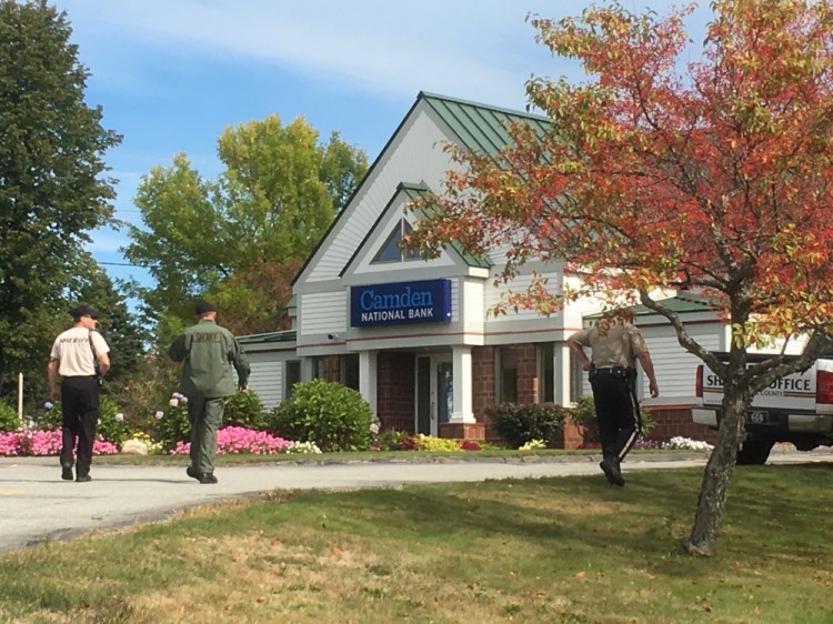 Police converge Sept. 30, 2016, on the Camden National Bank branch in Manchester after receiving a report about a robbery there.