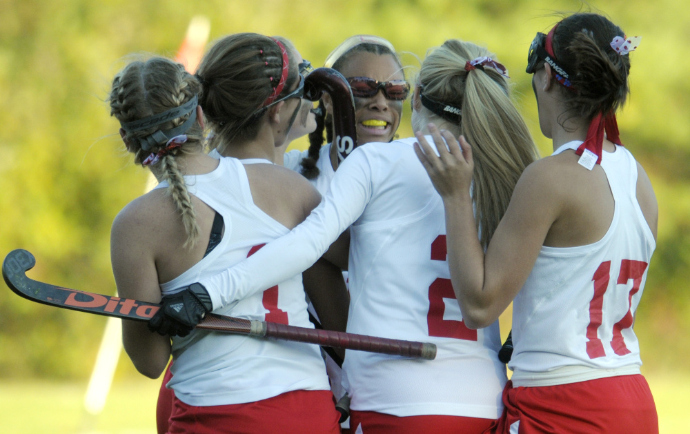 Teammates surround Cony's Kami Lambert, center, after she scored an overtime goal to beat Mt. Ararat in a Class A North quarterfinal game Tuesday in Augusta.