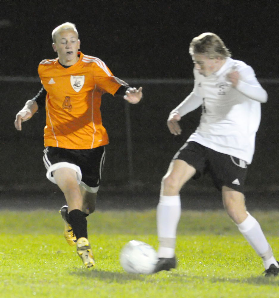 Winslow's Kaleb Burbank, left, tries to stop Maranacook's Mark McLaughlin during a Kennebec Valley Athletic Conference Class B game Tuesday in Readfield.