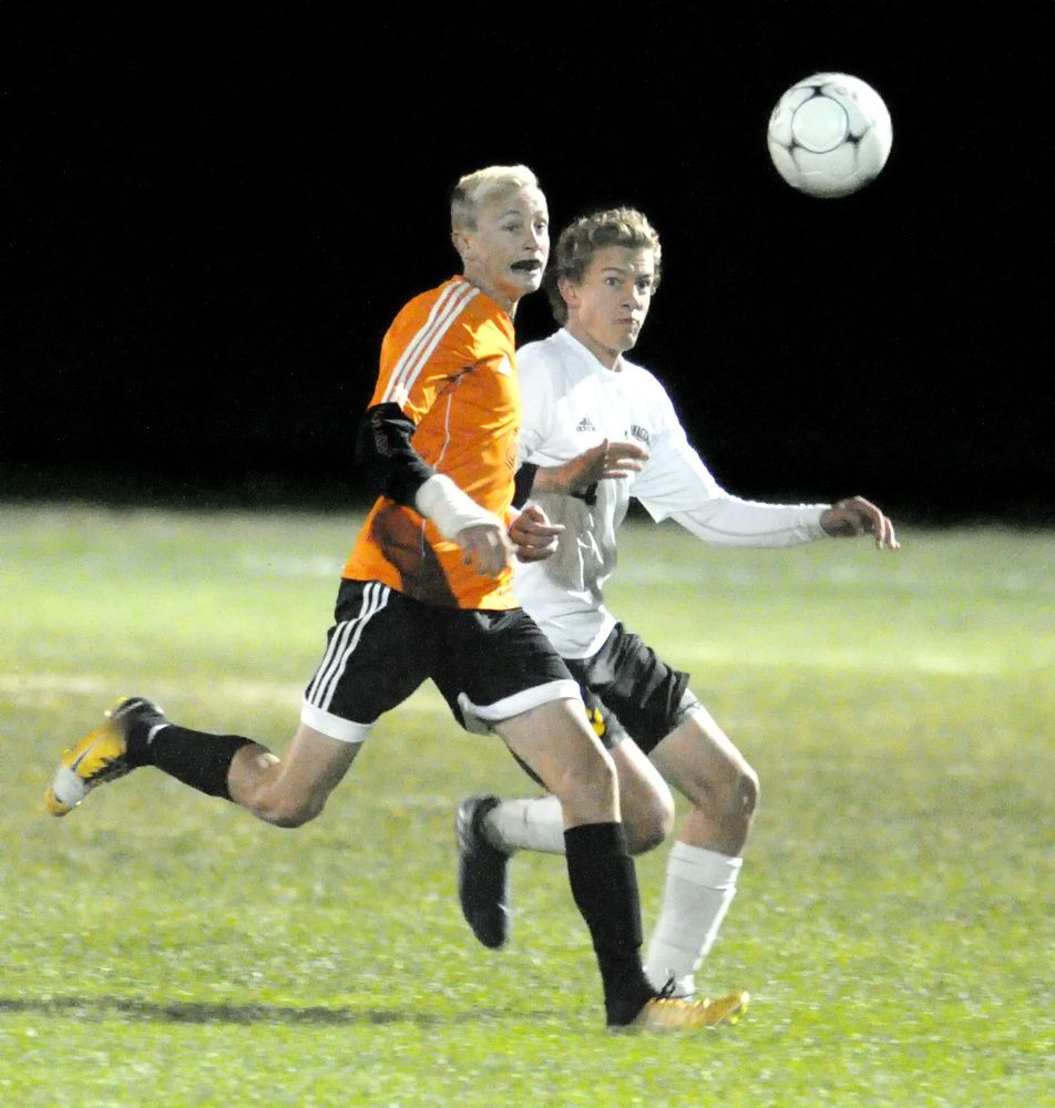 Winslow's Kaleb Burbank, left, and Maranacook's Connor Stockwell fight for a ball during a Kennebec Valley Athletic Conference Class B game Tuesday in Readfield.