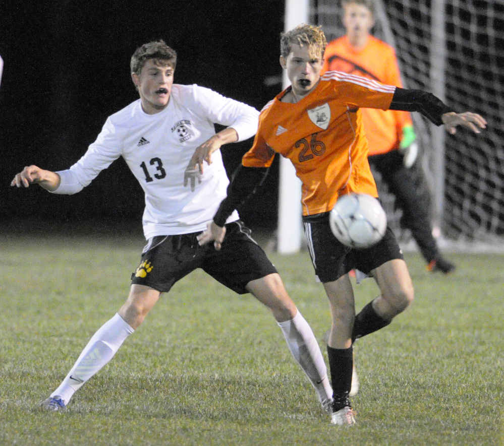 Maranacook's Silas Mohlar, left, and Winslow's Daylon Carpenter battle for a ball during a Kennebec Valley Athletic Conference Class B game Tuesday in Readfield.