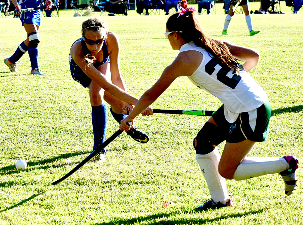 Oak Hill's Adelle Surette takes a swipe at the ball as Spruce Mountain junior Emily White (27) tries to intervene in a Class C South quarterfinal game Wednesday in Jay.