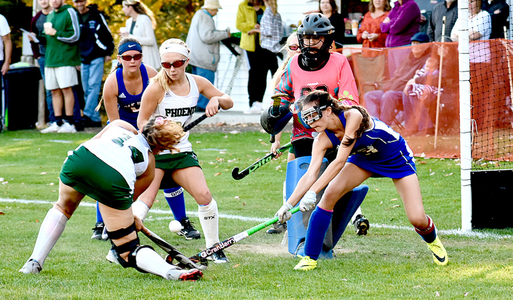 Spruce Mountain's Emily Goding (14) battles for the ball with Oak Hill's Alexis Faucher, right, during a Class C South quarterfinal game Wednesday in Jay.