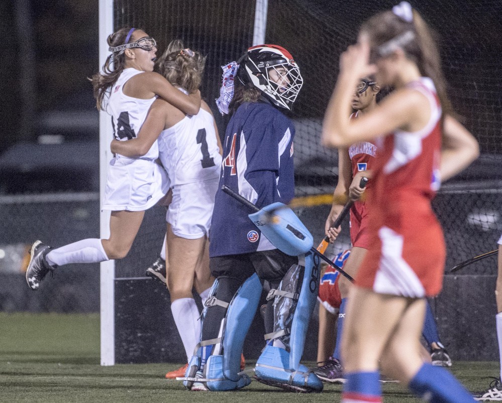 Skowhegan's Alexis Michonski (14) jumps into the arms of teammate Julia Steeves after a first half goal against Messalonskee in the Class A North championship game Tuesday at Hampden Academy.