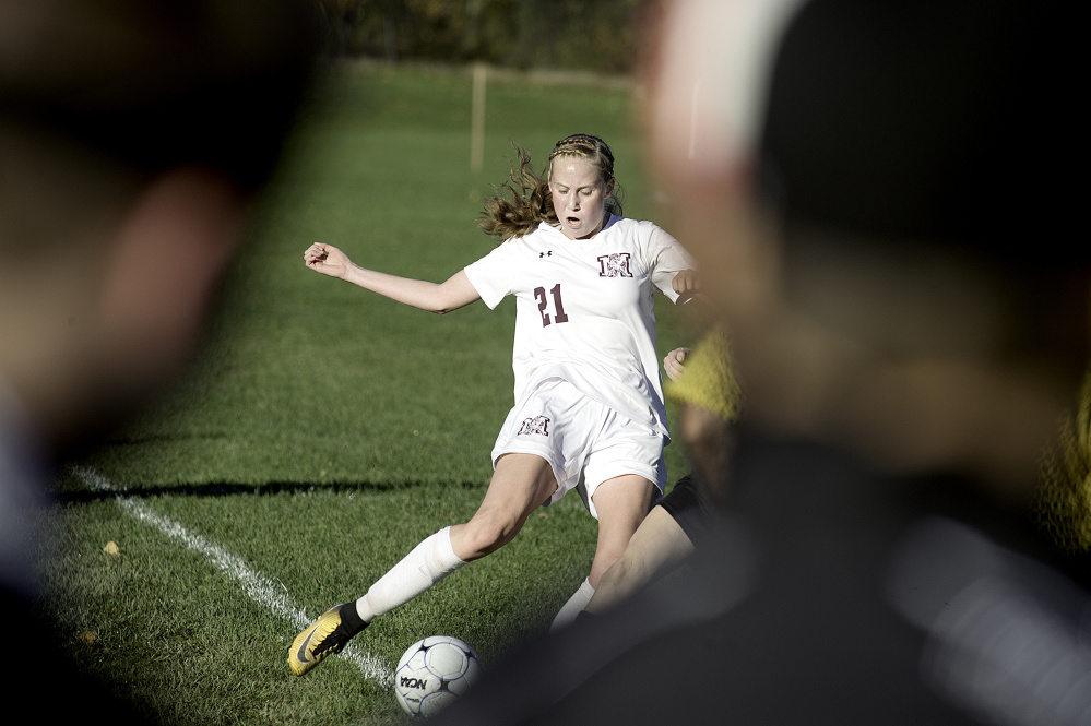 Monmouth's Anna Lewis tries to keep the ball inbounds against St. Dominic in a Class C South semifinal game Friday in Monmouth.