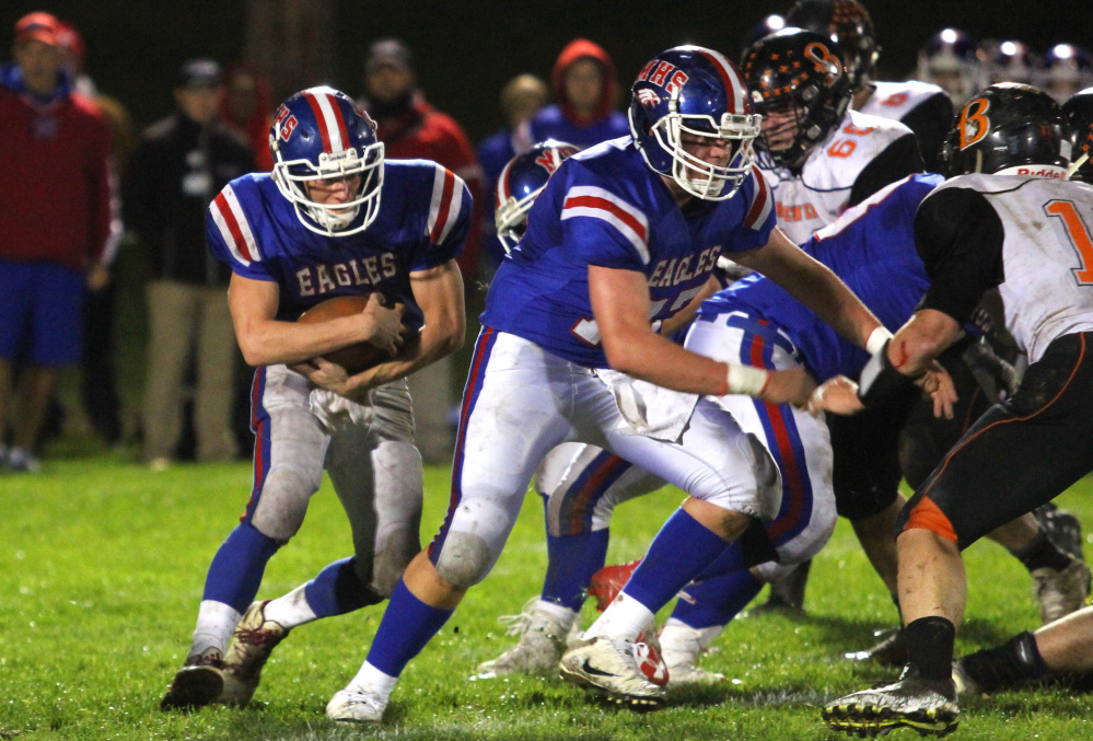 Messalonskee running back Tyler Lewis follows a block by Colin Kinney during first-half action against Brewer in Oakland on Friday night.