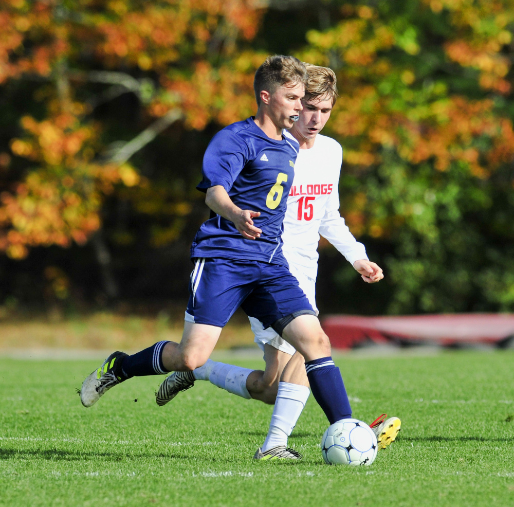 Traip's Charlie Driscoll, left, tries to get around Hall-Dale defender Beaux Vachon during a Class C South semifinal Saturday in Farmingdale.