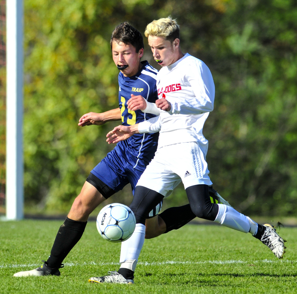 Traip's Connor Reed (25) defends Hall-Dale's Josh Nadeau during a Class C South semifinal Saturday in Farmingdale.