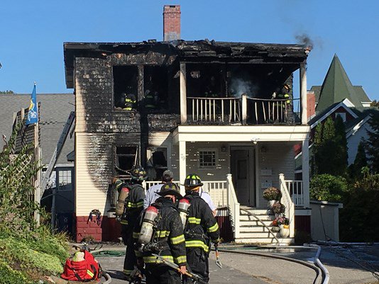 Portland firefighters gather outside 79 Lincoln Street on the morning of Saturday Oct. 21, 2017.
