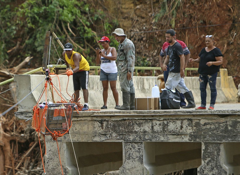 Residents of Rio Abajo, Puerto Rico, receive a shopping cart full of necessities sent from a nearby town as recovery efforts from Hurricane Maria continued late last month.