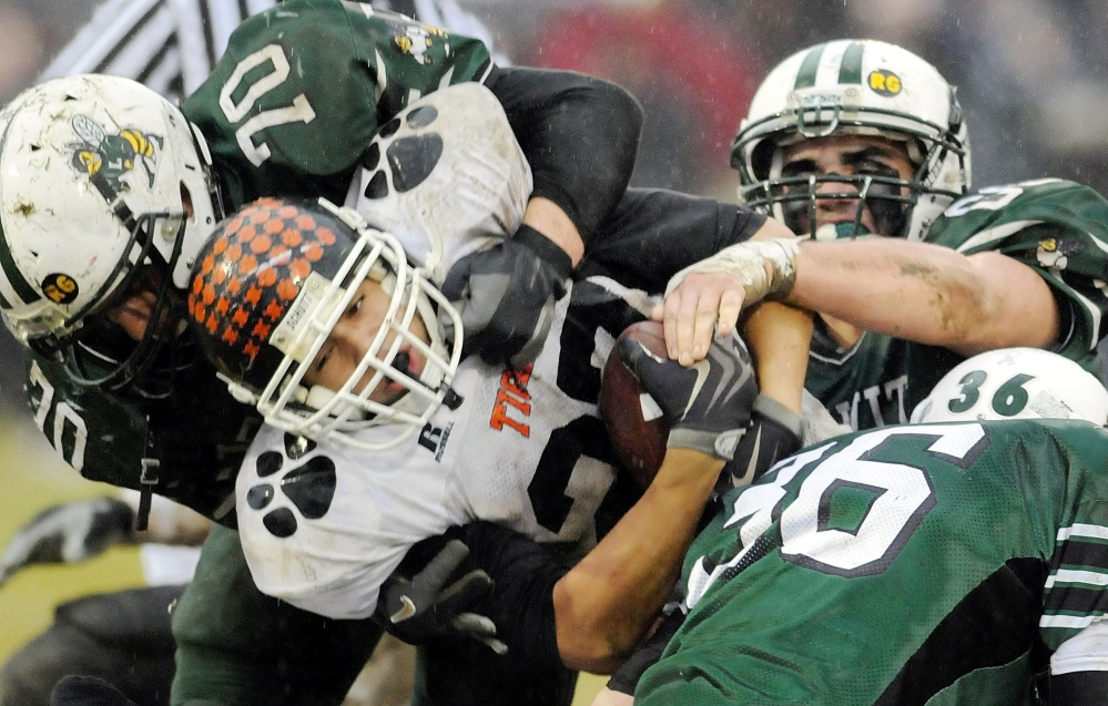 Staff file photo by Andy Molloy 
 Gardiner running back Alonzo Connor tries to squeeze through three Leavitt defenders during the 2009 Pine Tree Conference Class B championship game in Turner.
