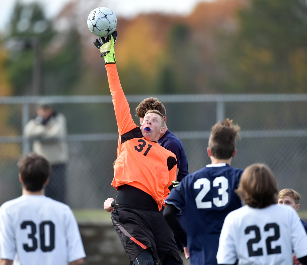 Winslow goalie Jake Lapierre (31) makes a save in the first half off a Yarmouth corner kick during the Class B state championship game last season at Hampden Academy.