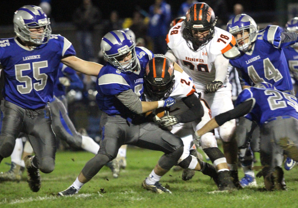 Lawrence's Spencer Trask wrestles Brunswick's Dalton Dickey to the ground during first-half of a Pine Tree Conference Class B semifinal game against Brunswick on Friday night in Fairfield.